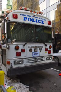 Image of bus branded with NYPD police text.