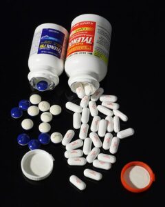 Photograph of Tylenol bottles with pills falling out.
